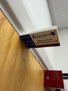 Fire door gap inspection carried out during b2b commercial maintenance works.