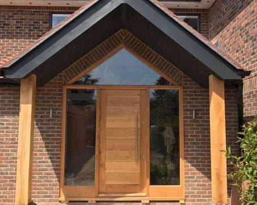 Modern brick extension with wooden door and windows